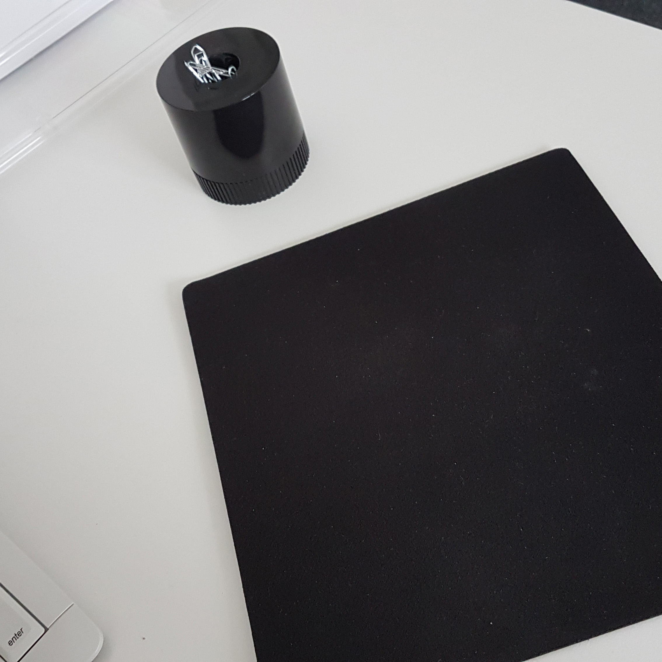 Mouse pad, paper clips on the table